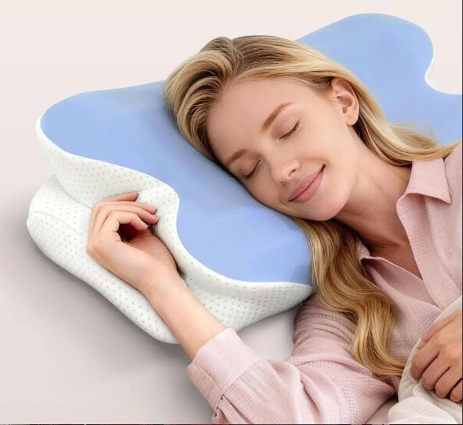 A woman resting on her side, one arm cradled through the pillow's open arm channel