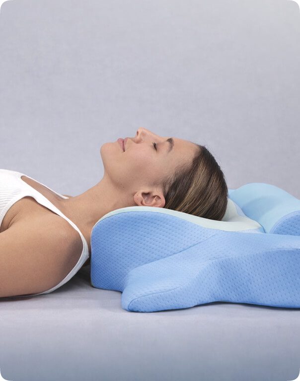 Back sleeping position with neck supported by the pillow's central cradle